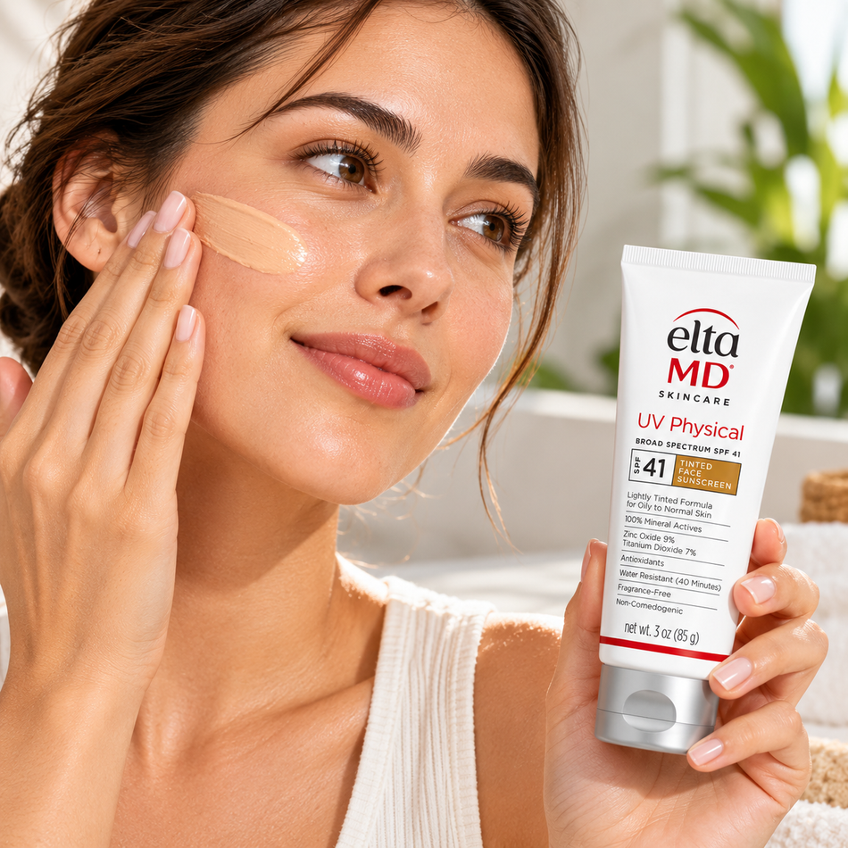 Woman applying EltaMD UV Physical Tinted SPF 41 mineral sunscreen to her cheek while holding the 3 oz tube, showcasing the lightweight tinted formula during a daily skincare routine.