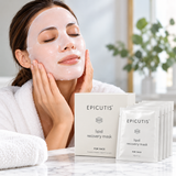 Woman applying Epicutis Lipid Recovery Mask facial sheet mask during a relaxing skincare routine, with a box of five 0.7 oz hydrating face masks.
 Copy