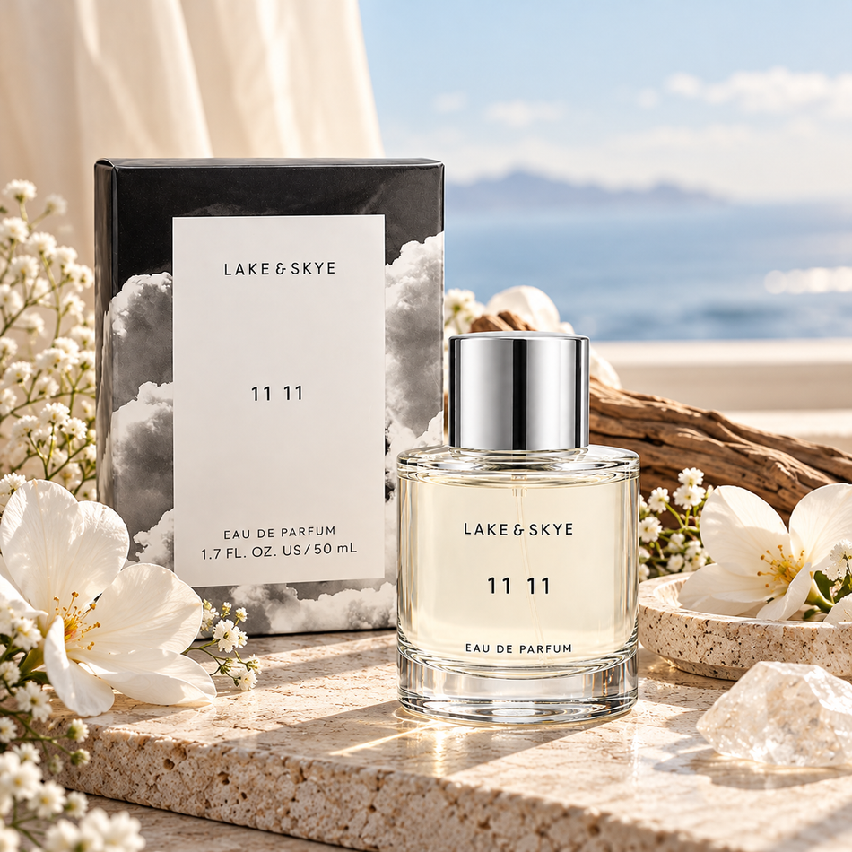 Lake & Skye 11 11 Eau de Parfum 50 mL perfume bottle with silver cap and cloud-design packaging displayed on a marble surface in an elegant luxury fragrance setting.
