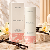 Lake & Skye 11 11 Vanilla Body Oil 3.4 oz (100 ml) premium product display featuring cream and pink packaging, vanilla orchids, and elegant marble background.
