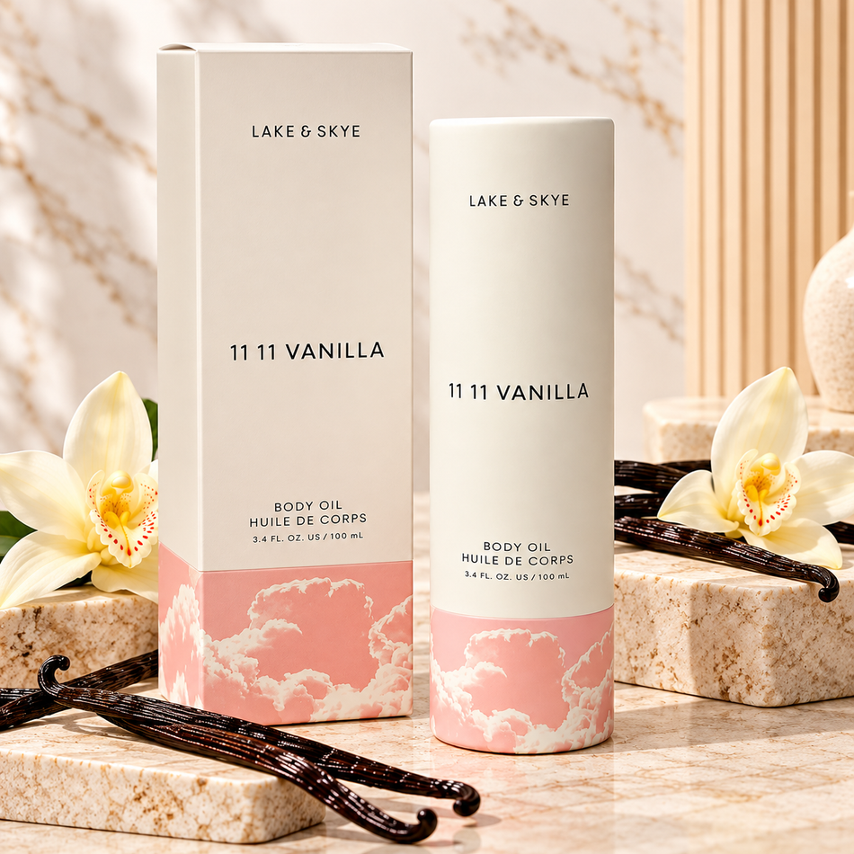 Lake & Skye 11 11 Vanilla Body Oil 3.4 oz (100 ml) premium product display featuring cream and pink packaging, vanilla orchids, and elegant marble background.