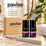 Pavise Bioadaptive Stress Repair Mini 2 x 5ml skincare set featuring two black bottles and kraft packaging displayed on a luxury marble vanity with natural lighting.