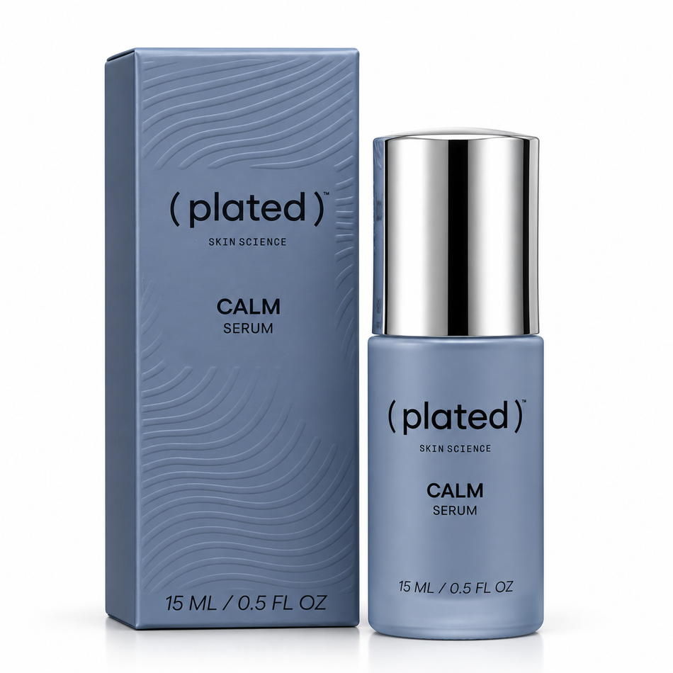 Plated Skin Science CALM Serum 15mL displayed with blue packaging on a marble vanity alongside a soft white towel and greenery in a luxury skincare setting.