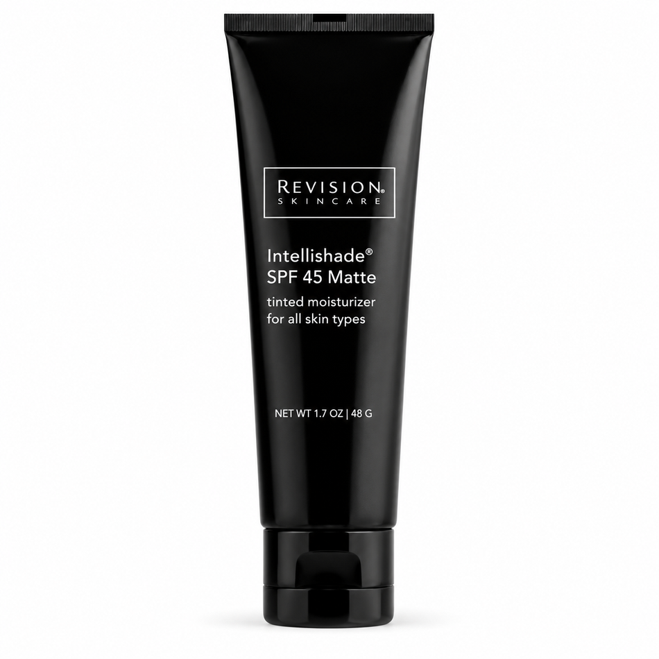 Woman applying Revision Skincare Intellishade SPF 45 Matte Tinted Moisturizer 1.7 oz to her cheek, showcasing its creamy tinted texture and natural-looking finish during a daily skincare routine.