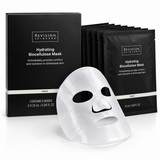 Woman wearing Revision Skincare Hydrating Biocellulose Facial Mask during a relaxing skincare routine, with the black 6-pack product box and individual mask sachet displayed beside her.